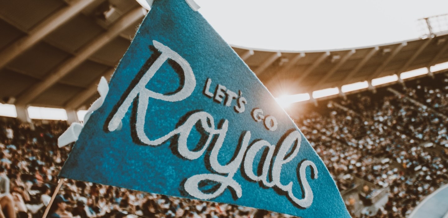 Let's Go Royals flag at the KC Royals stadium with a crowd of fans
